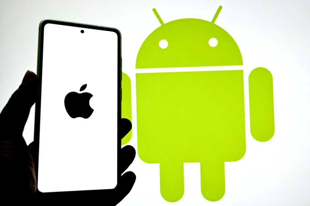 In this photo illustration, an Apple logo is seen displayed